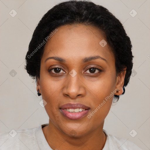 Joyful black adult female with short  black hair and brown eyes
