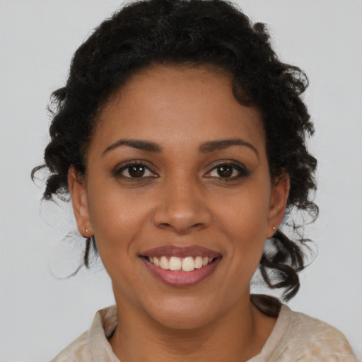 Joyful latino young-adult female with medium  brown hair and brown eyes