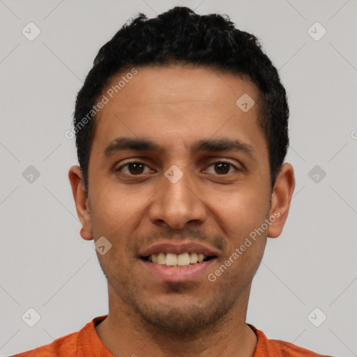 Joyful latino young-adult male with short  black hair and brown eyes