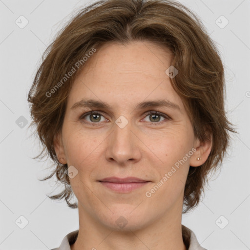 Joyful white adult female with medium  brown hair and grey eyes