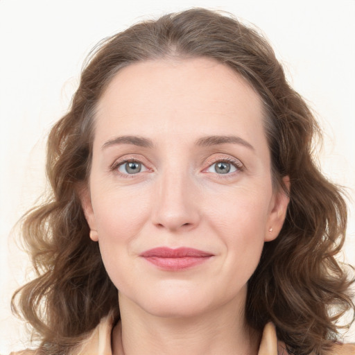 Joyful white young-adult female with medium  brown hair and green eyes