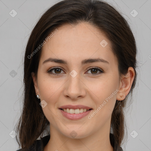 Joyful white young-adult female with long  brown hair and brown eyes