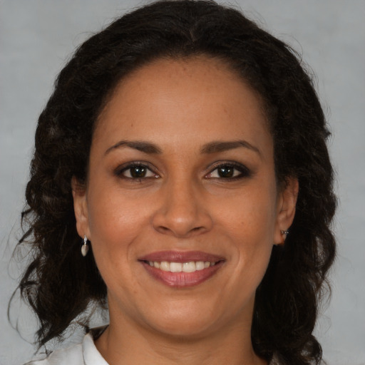 Joyful black adult female with medium  brown hair and brown eyes