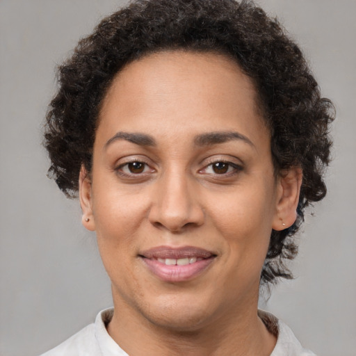 Joyful latino adult female with short  brown hair and brown eyes