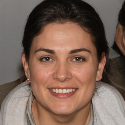 Joyful white young-adult female with medium  brown hair and brown eyes