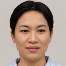 Joyful asian young-adult female with short  black hair and brown eyes