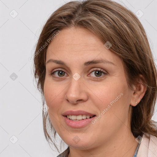 Joyful white adult female with medium  brown hair and grey eyes