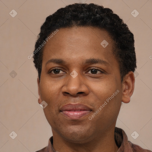 Joyful black young-adult male with short  brown hair and brown eyes