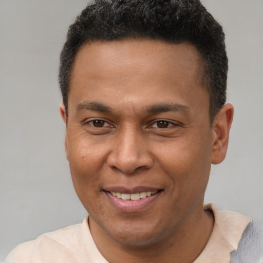 Joyful latino young-adult male with short  brown hair and brown eyes