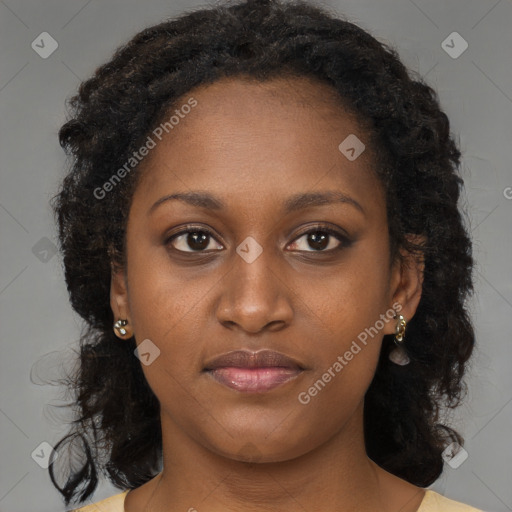 Joyful black young-adult female with long  brown hair and brown eyes