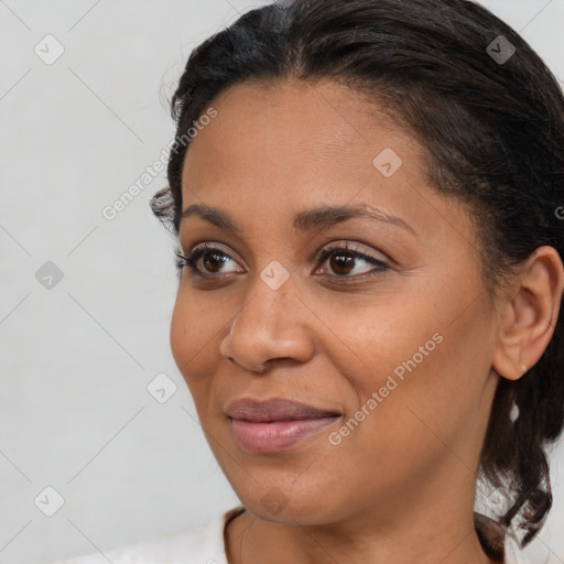 Joyful black young-adult female with medium  brown hair and brown eyes