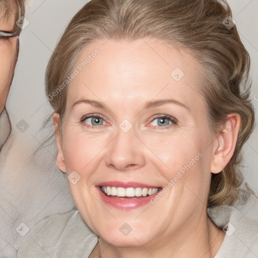 Joyful white adult female with medium  brown hair and blue eyes