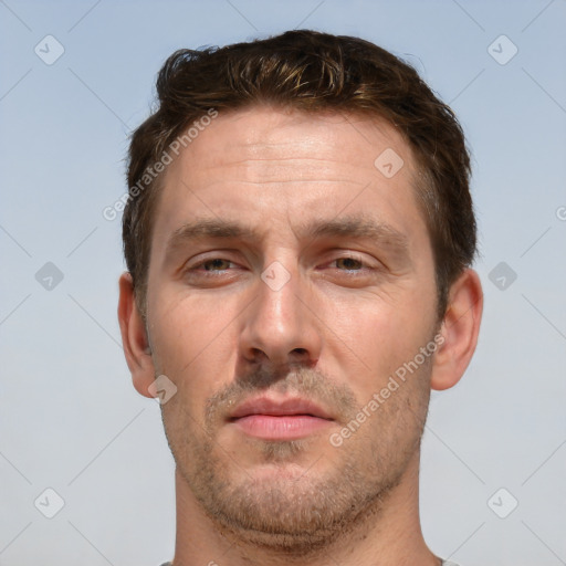 Joyful white adult male with short  brown hair and brown eyes