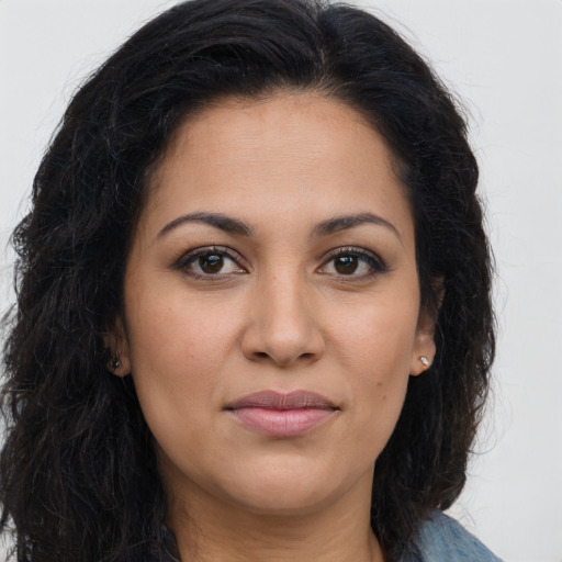 Joyful latino young-adult female with long  brown hair and brown eyes