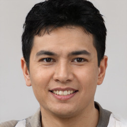 Joyful asian young-adult male with short  brown hair and brown eyes