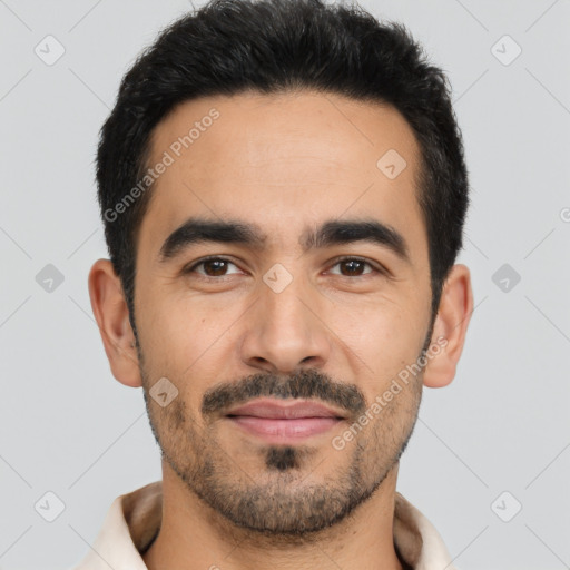 Joyful latino young-adult male with short  black hair and brown eyes