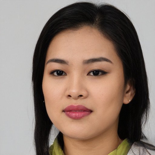 Joyful asian young-adult female with medium  black hair and brown eyes
