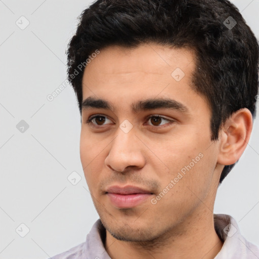 Joyful latino young-adult male with short  black hair and brown eyes