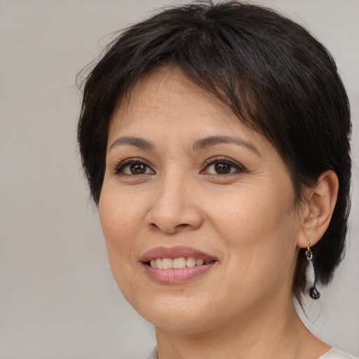 Joyful white adult female with medium  brown hair and brown eyes