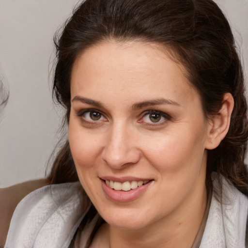 Joyful white young-adult female with medium  brown hair and brown eyes