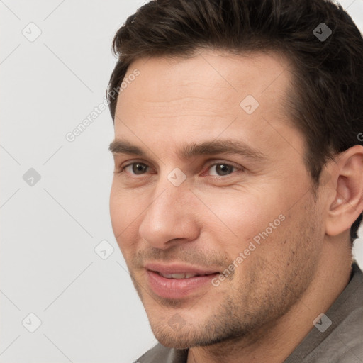 Joyful white young-adult male with short  brown hair and brown eyes