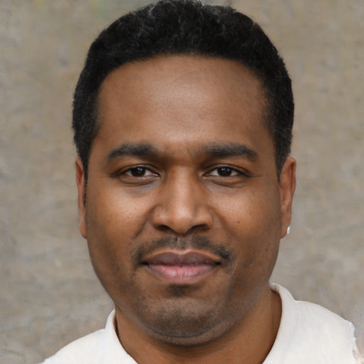 Joyful black young-adult male with short  black hair and brown eyes