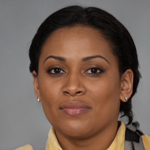 Joyful black young-adult female with medium  brown hair and brown eyes
