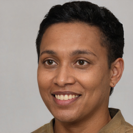 Joyful black adult female with short  brown hair and brown eyes
