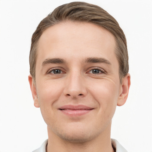 Joyful white young-adult male with short  brown hair and grey eyes