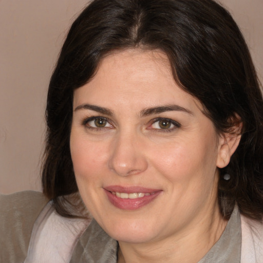 Joyful white adult female with medium  brown hair and brown eyes