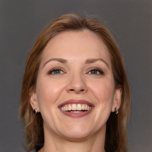 Joyful white adult female with medium  brown hair and brown eyes