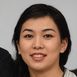 Joyful asian young-adult female with medium  black hair and brown eyes