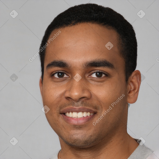 Joyful black young-adult male with short  black hair and brown eyes