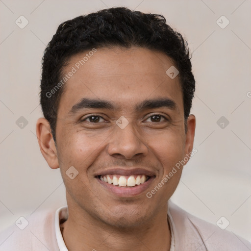 Joyful latino young-adult male with short  brown hair and brown eyes