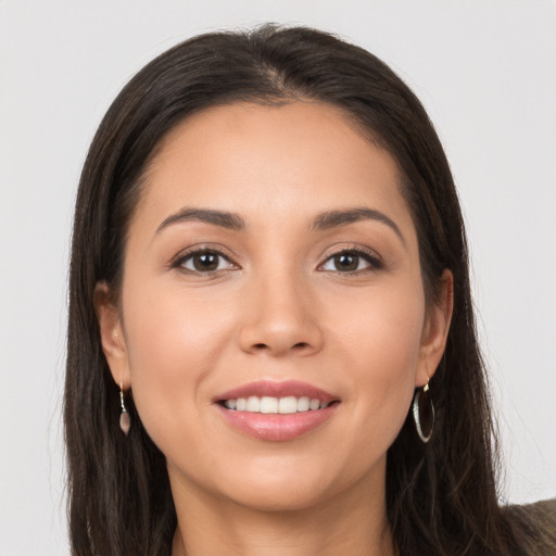 Joyful white young-adult female with long  brown hair and brown eyes