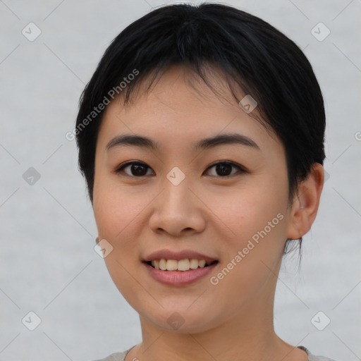 Joyful asian young-adult female with short  brown hair and brown eyes