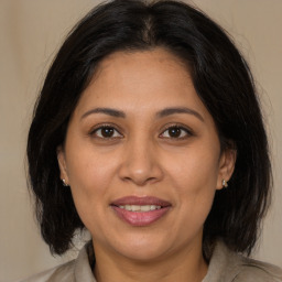 Joyful white adult female with medium  brown hair and brown eyes