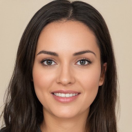 Joyful white young-adult female with long  brown hair and brown eyes