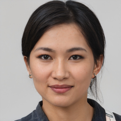Joyful white young-adult female with medium  black hair and brown eyes