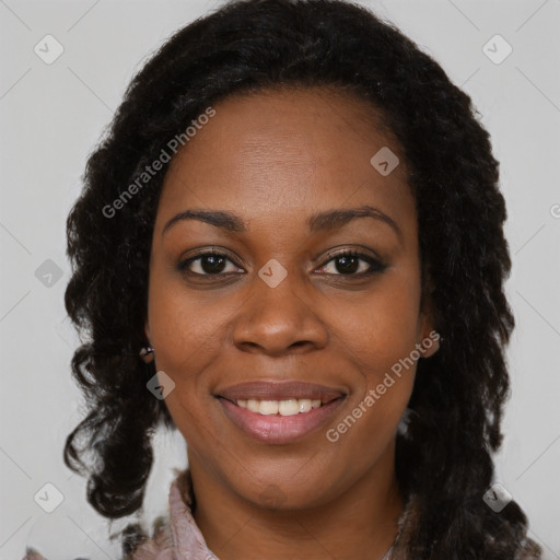 Joyful black young-adult female with long  brown hair and brown eyes