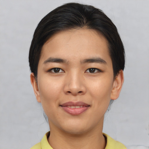 Joyful asian young-adult female with short  brown hair and brown eyes
