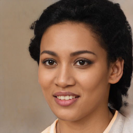 Joyful latino young-adult female with short  black hair and brown eyes