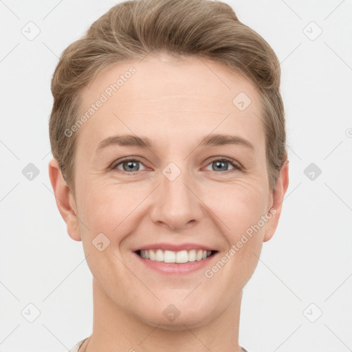 Joyful white young-adult female with short  brown hair and grey eyes