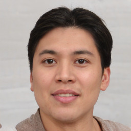 Joyful asian young-adult male with short  brown hair and brown eyes