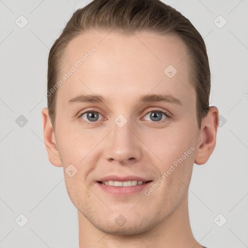 Joyful white young-adult male with short  brown hair and grey eyes