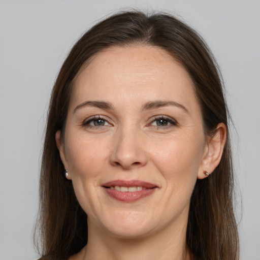 Joyful white adult female with long  brown hair and brown eyes