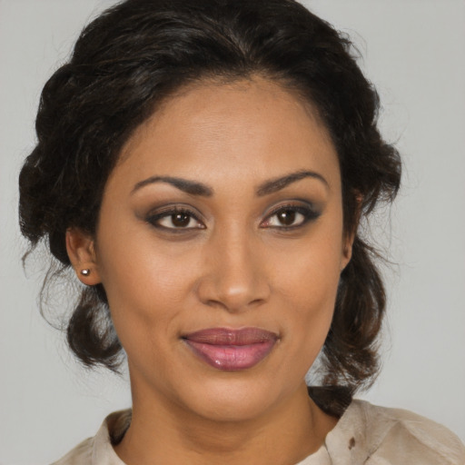 Joyful black young-adult female with medium  brown hair and brown eyes