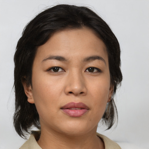 Joyful asian young-adult female with medium  brown hair and brown eyes
