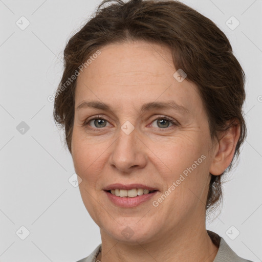 Joyful white adult female with medium  brown hair and grey eyes