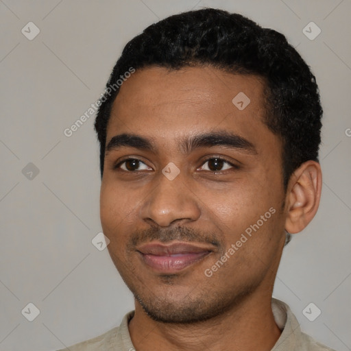 Joyful black young-adult male with short  black hair and brown eyes